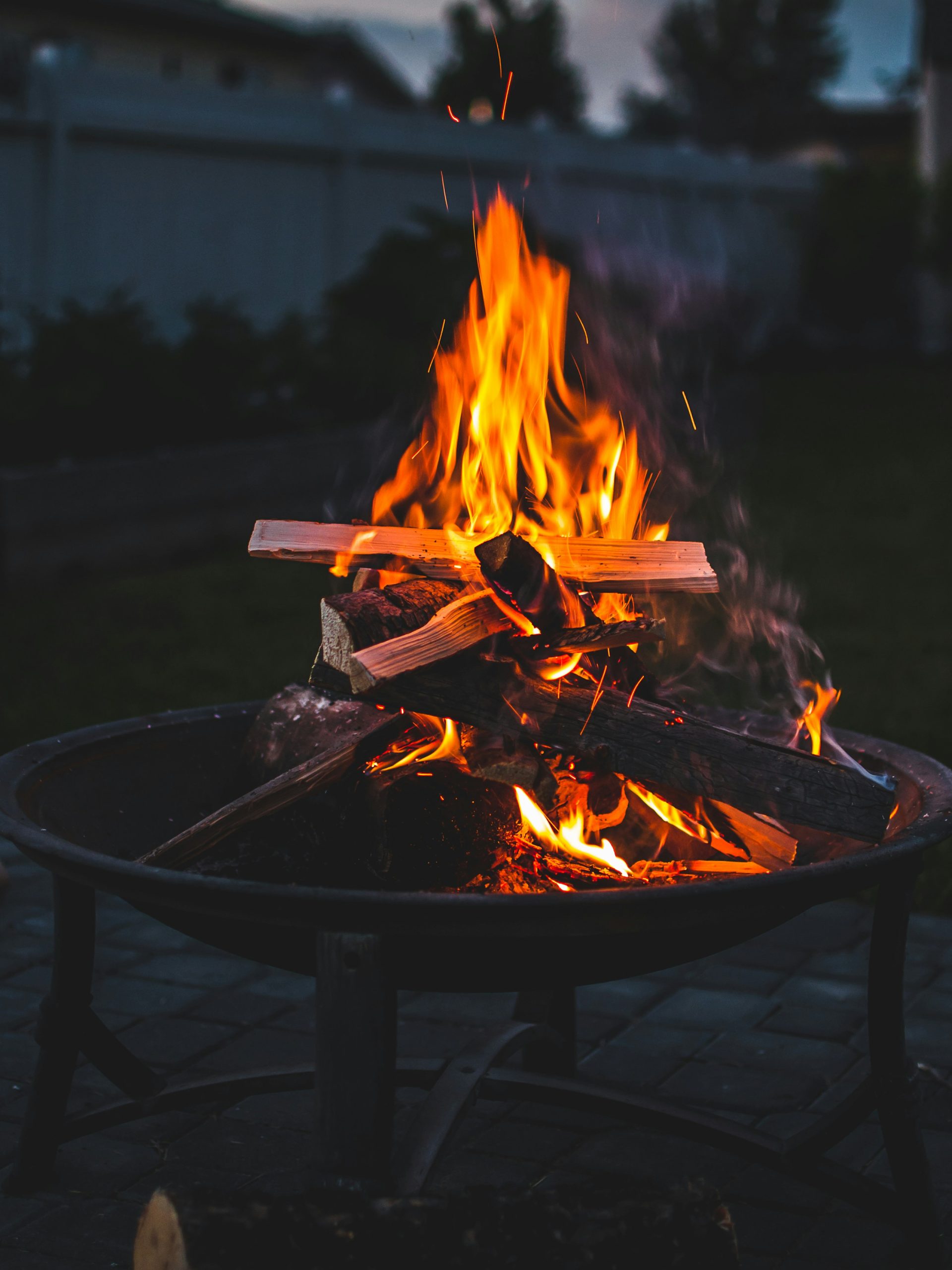 Smokeless fire pit glowing on a patio at dusk
